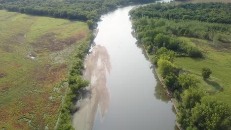 Drone-aerial-view-of-following-the-Iowa-River-water-trail-with-large-sandbar-in-river