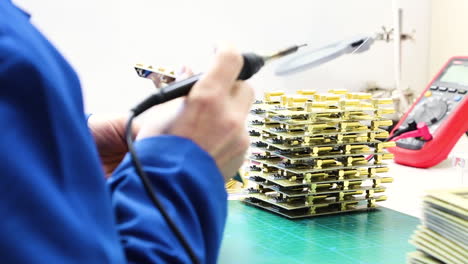 Engineer Check Electronic Components at a workshop with soldering in his hand