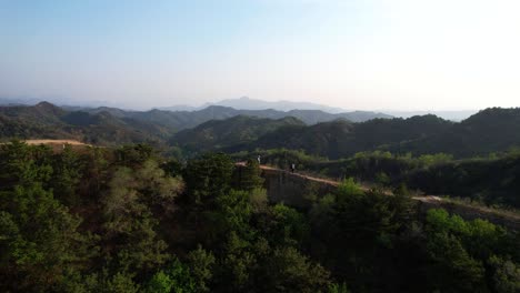 Couple-walking-through-dust-path-in-mountainous-landscape-of-Gubeikou-Great-Wall,-China