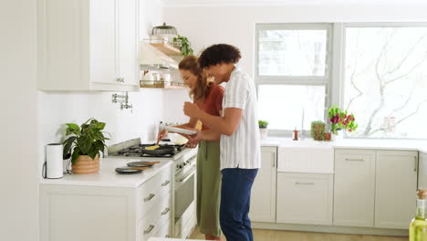 diverse couple cooking together in modern kitchen, enjoying quality time and preparing meal, at home