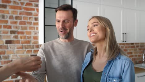 close up video of couple receives the keys to a new apartment