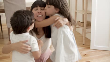 niño y niña abrazándose y besándose madre feliz