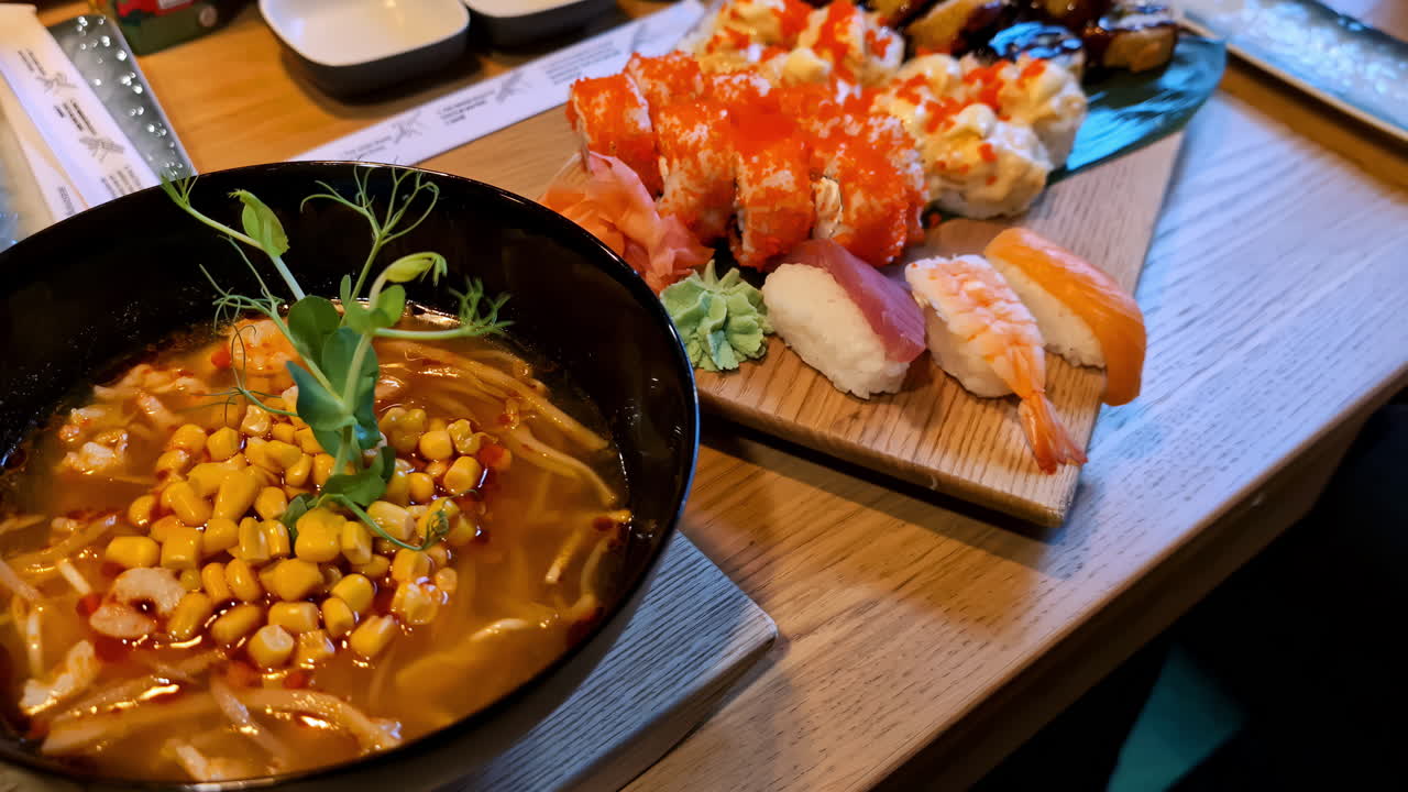 Assorted sushi displayed on a wooden board, with rolls and nigiri included