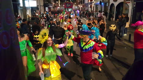 a woman and a man in disguise dancing at the carnival in las palmas de gran canaria, canary islands, spain. shot taken from a float. 4k
