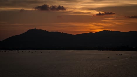 sunset over phuket island big buddah thailand