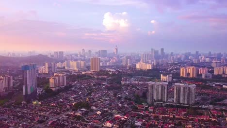 Pull-away-aerial-shot-of-Kuchai-Lama-district-with-Bangsar-South-and-the-iconic-TM-Tower-in-the-background,-Kuala-Lumpur,-Malaysia