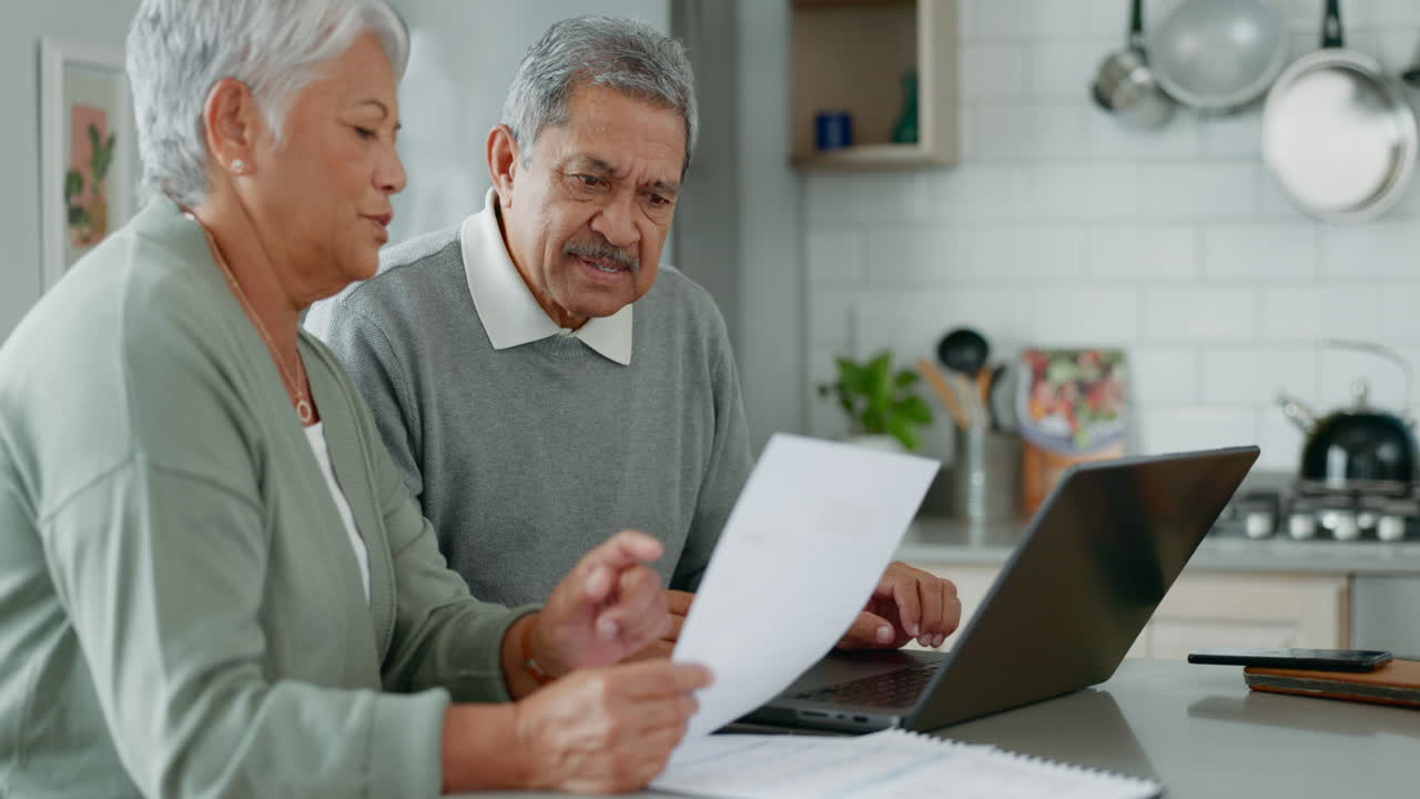 Document, laptop and elderly couple in kitchen