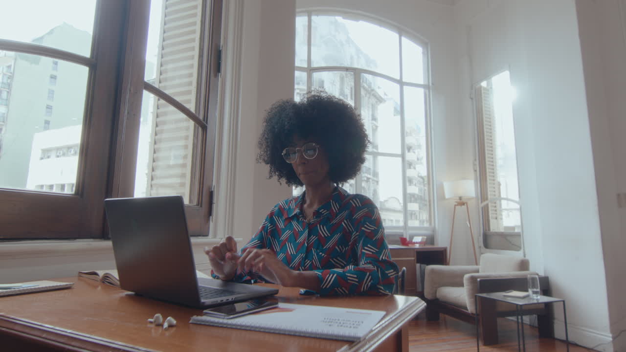 African-American Woman Web Calling on Laptop in the Office