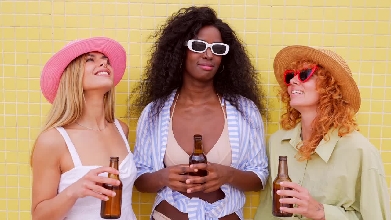Three friends enjoying beer on a sunny beach vacation