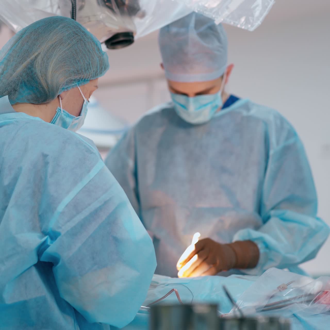 Surgery in the operating theatre. Professional doctor and a nurse performing an operation on a patient. Surgical concept.