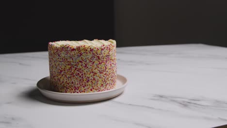 studio shot of birthday cake covered with hundreds and thousands decorations 9