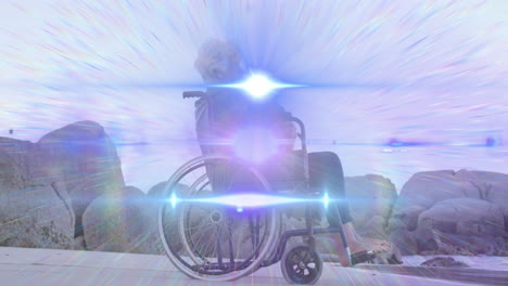 animation of light moving over smiling senior caucasian woman in wheelchair on beach looking to sea