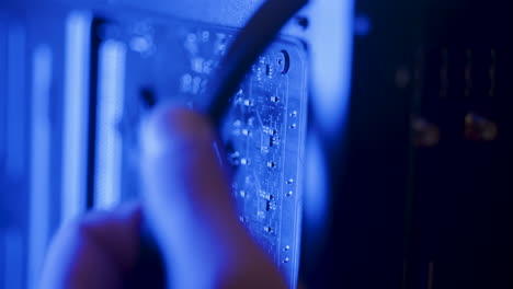 male technician fixing calbles on a pc