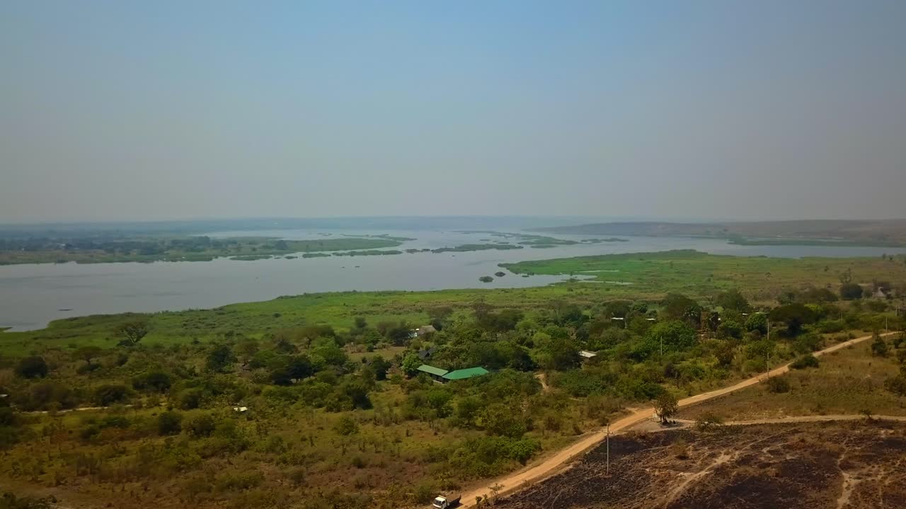 Wide angle drone view of safari lodges nestled on the banks of the Victoria Nile surrounded by savannah and wetlands in Murchison Falls National Park northwestern Uganda