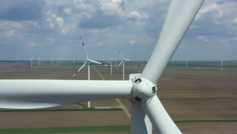 aerial view of several windmills, wind generators, turbines, producing renewable clean energy by converting kinetic energy