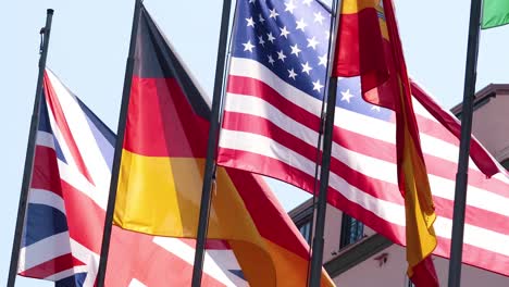 multiple national flags waving in the wind