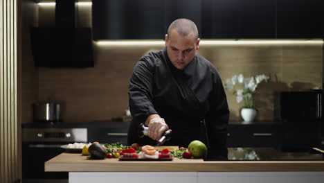 chef using a blowtorch to prepare food in a modern kitchen