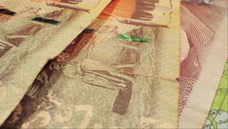 captivating closeup shots of various currency bills featuring mahatma gandhi, including rupees and dollars. unique onedollar bill with a hole. money handling and currency art captured in detail