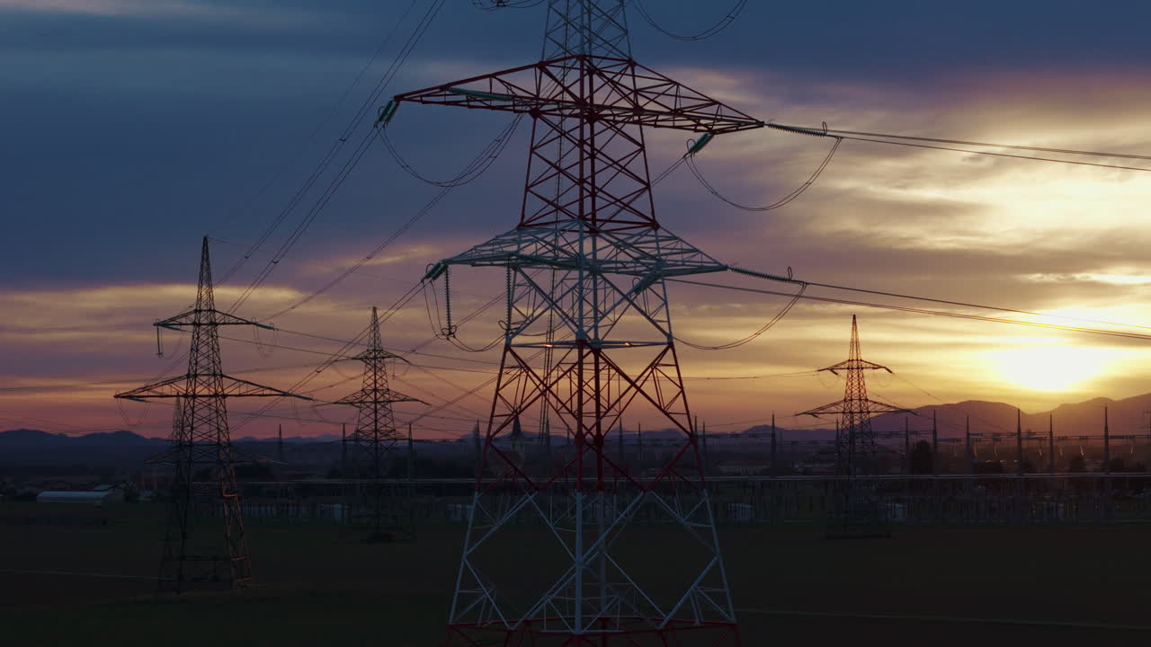 Highvoltage electrical substation switchyard shows transformers and transmission lines during