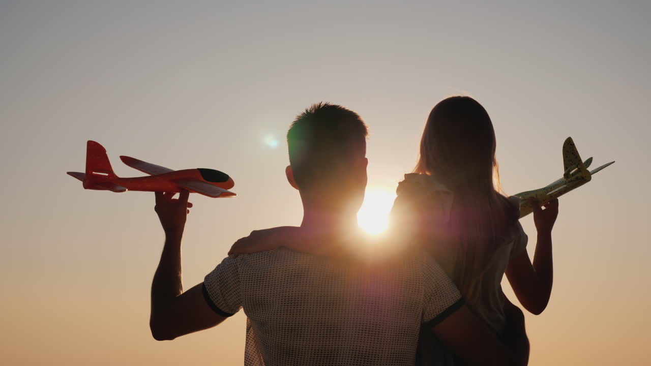 Man And Child Play With A Toy Airplane