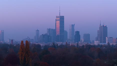 warsaw, poland. revealing drone shot of varso tower and business buildings on misty autumn sunset