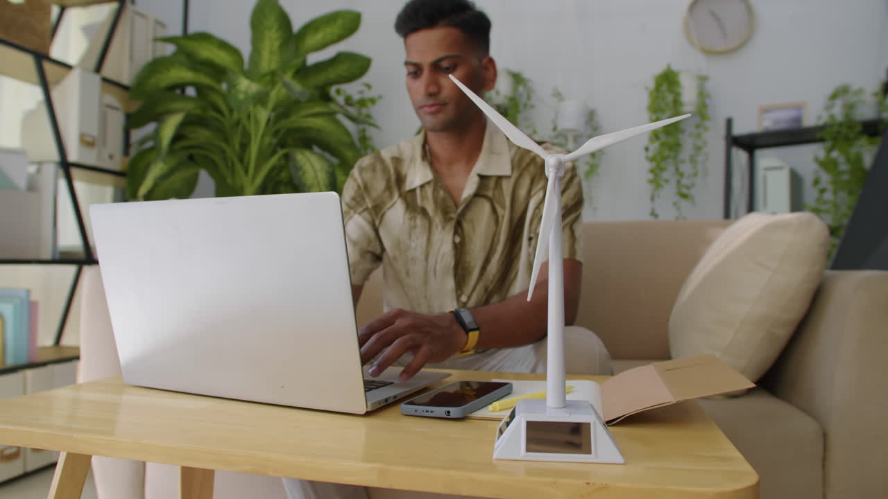 Manager Filling Report on Laptop about Environmental Project