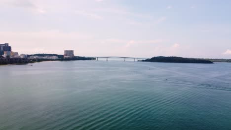aerial establishing view of bridge connecting sihanoukville city to island, surrounded by water and coastline