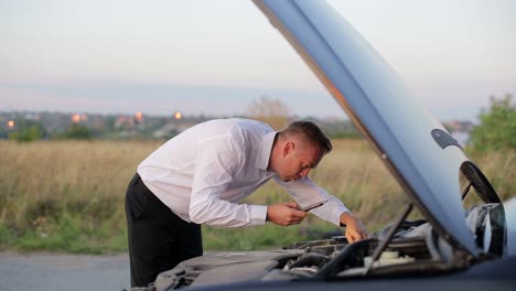 Businessman with the Problem of Checking the Car under the Hood Businessman with the Problem of Checking the Car under the Hood Car Crash