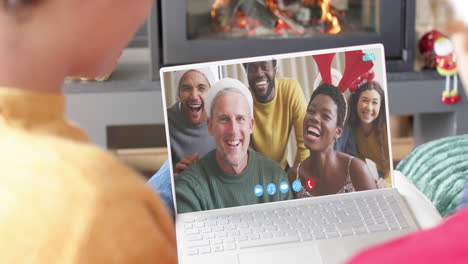 happy diverse couple and friends having christmas laptop video call, slow motion