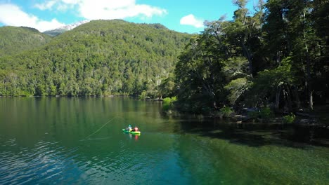 Aerial-of-two-men-kayaking-across-Lake-Steffen-catching-trouts-with-dry-fly-fishing-technique,-Patagonia-Argentina