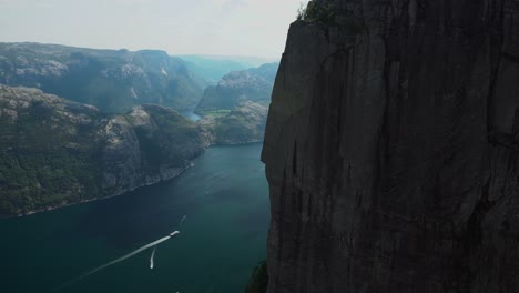 epic view down from preikestolen edge in to the abyss of pulpit rock in norway