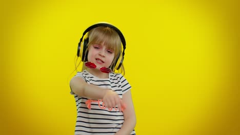 funny child kid girl making playful silly facial expressions and grimacing, fooling, showing tongue