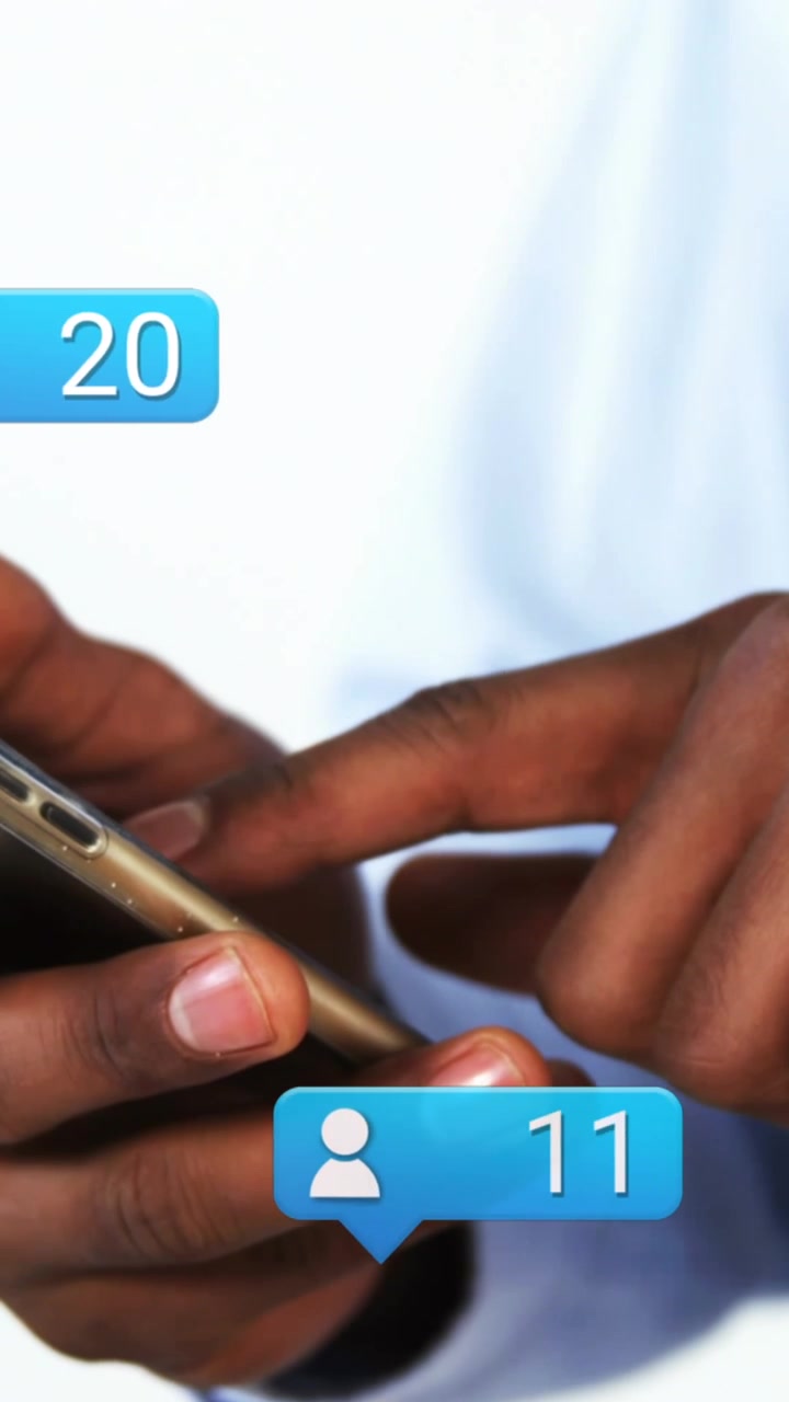 Animation of social media icons falling over person using smartphone