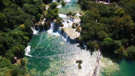 amazing aerial view panning up revealing lakes and waterfalls at krka national park in dalmatia, croatia filmed in 4k