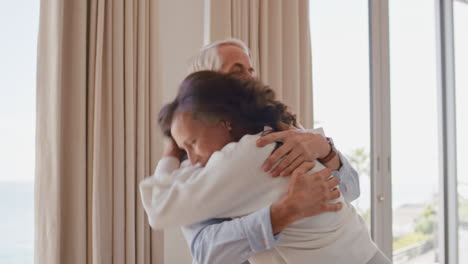 happy-mature-couple-dancing-at-home-enjoying-successful-relationship-having-fun-celebrating-anniversary-retirement