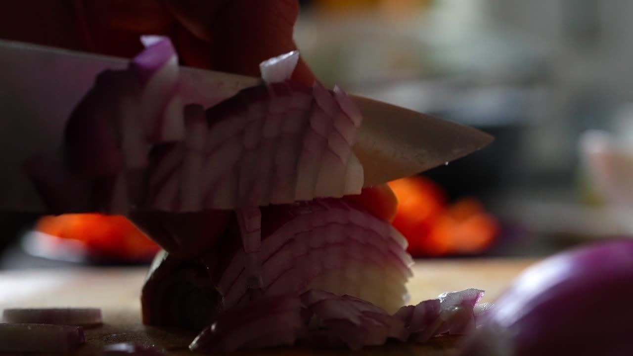 Vegetable Chef dicing red onions in food kitchen preparation Close-Up