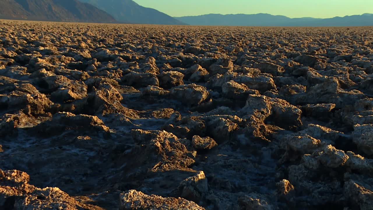 Devil's Golf Course, Large Salt Pan On The Floor of Death Valley National Park In California, USA. Tilt-up Shot