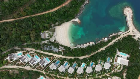 beautiful top-down view of a hotel resort on a white beach with cozy houses in saranda, albania.