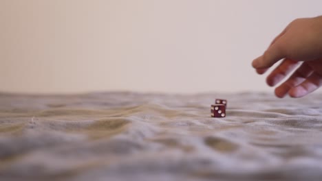 smokey red dice being thrown and then picked up in slow motion, ramped to regular