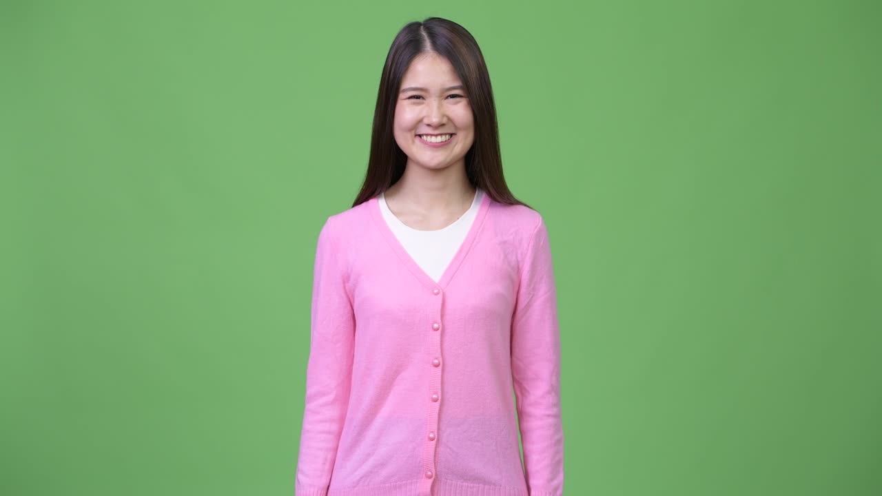 Young happy beautiful Asian woman smiling
