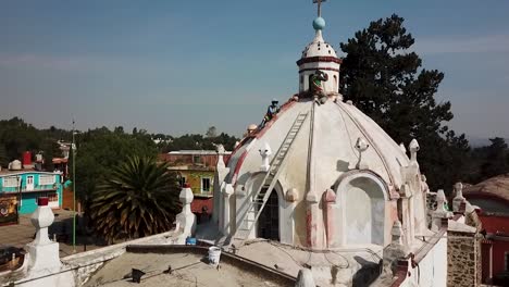 workers repairing the dome of a church in mexico