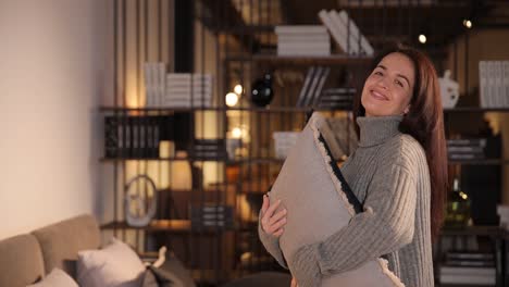 woman with pillow in living room