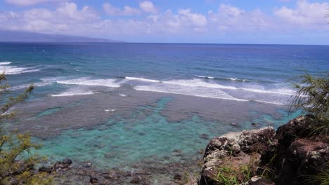 timelapse of small waves breaking on a shallow reef just off the coastline