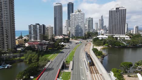 Two-modern-electric-trams-pass-along-the-Gold-Coast-city-light-rail-towards-the-Surfers-Paradise-tourist-precinct