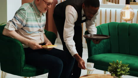 elderly person paying for coffee cup