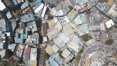 drone aerial, bird's-eye view of comuna 13 slums and escalator in medellin, colombia