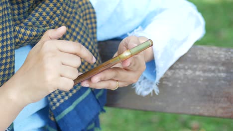 woman using phone in a park