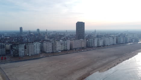 Aerial-flying-backwards-over-Ostend-beach,-Belgium