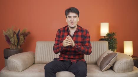 man giving greeting and applause to camera.