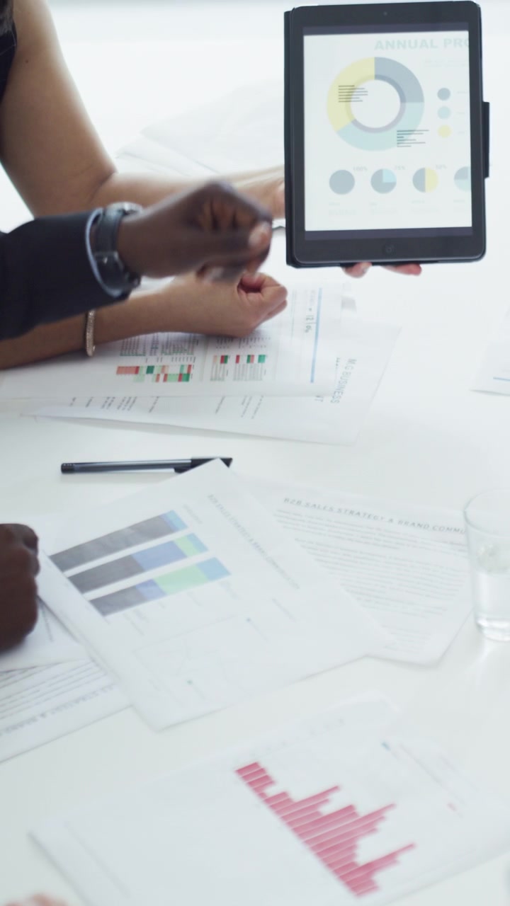 Business Team Analyzing Financial Charts and Data in Meeting